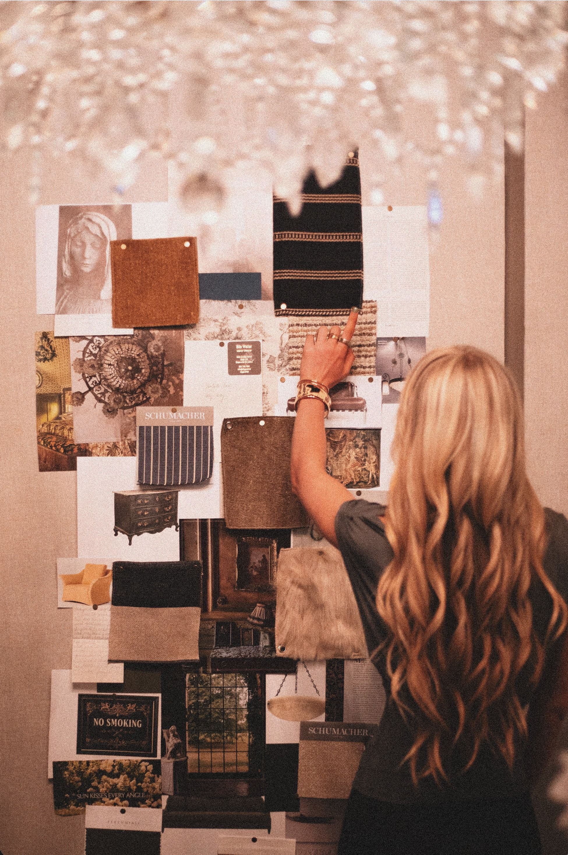 Designer arranging photographs and textile samples on a mood board